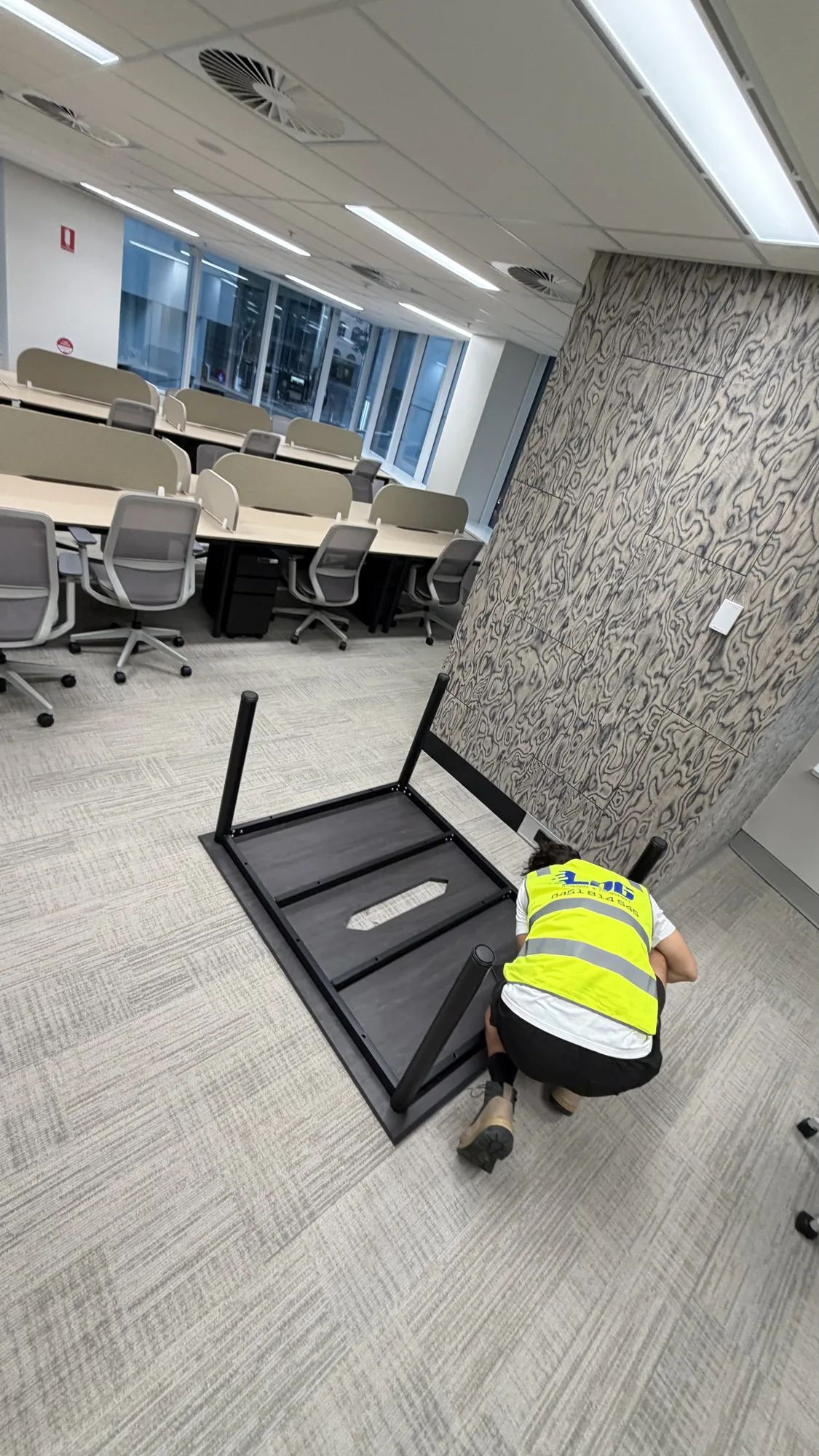 LOG Transport mover dismantling an office desk for reassembly at the new premises
